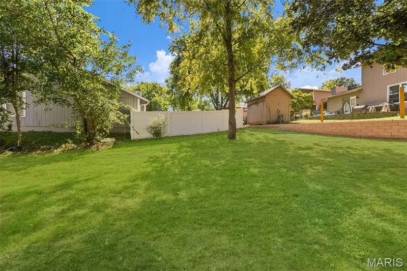 AI-enhanced image. Grass digitally restored to illustrate anticipated appearance following recent landscaping/retaining wall w — 18 Craigwood Drive, St Peters, MO 63376