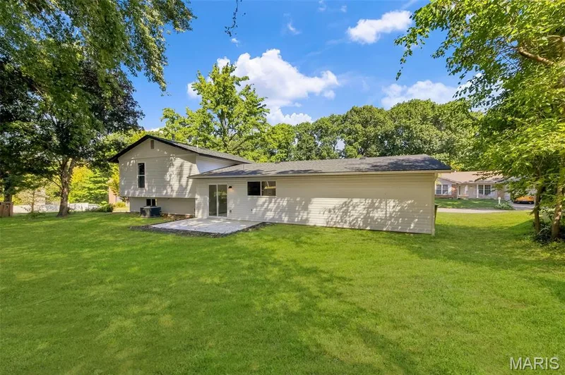 AI-enhanced image. Grass digitally restored to illustrate anticipated appearance following recent landscaping/retaining wall w — 18 Craigwood Drive, St Peters, MO 63376