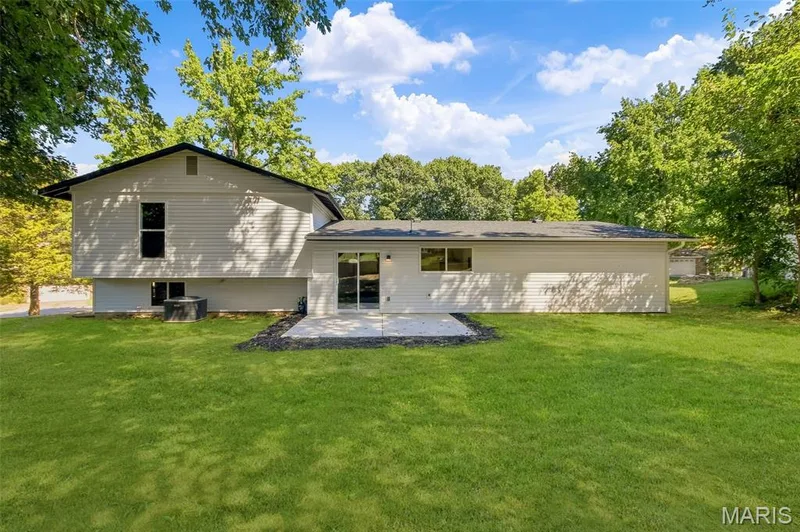AI-enhanced image. Grass digitally restored to illustrate anticipated appearance following recent landscaping/retaining wall w — 18 Craigwood Drive, St Peters, MO 63376