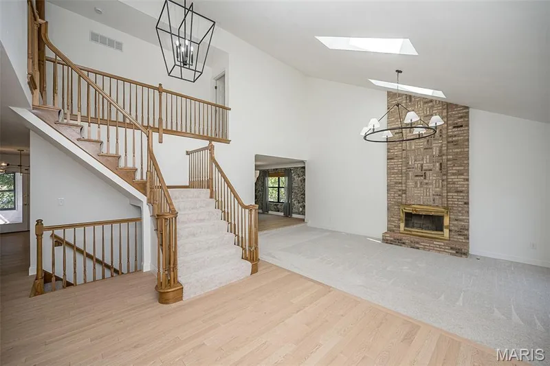 More amazing brick work on the floor to ceiling fireplace in the sunken living room. — 440 Meramec Way, St Charles, MO 63303