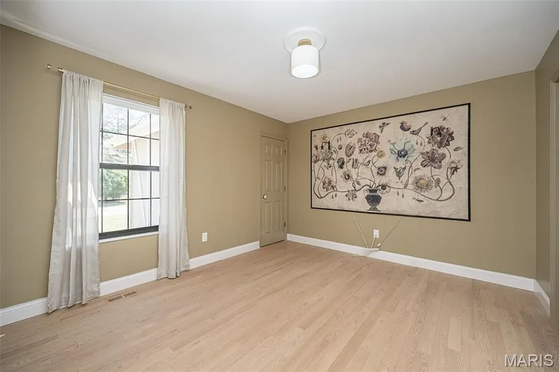 Main floor bedroom or office features a closet and access to the main floor bathroom. — 440 Meramec Way, St Charles, MO 63303