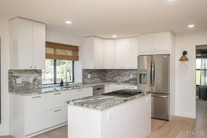 Gorgeous countertops that flow up the backsplash for an upscale seamless look — 440 Meramec Way, St Charles, MO 63303