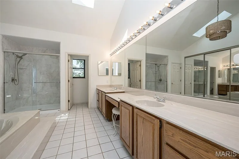 Primary bathroom features an oversized double vanity with seating. — 440 Meramec Way, St Charles, MO 63303