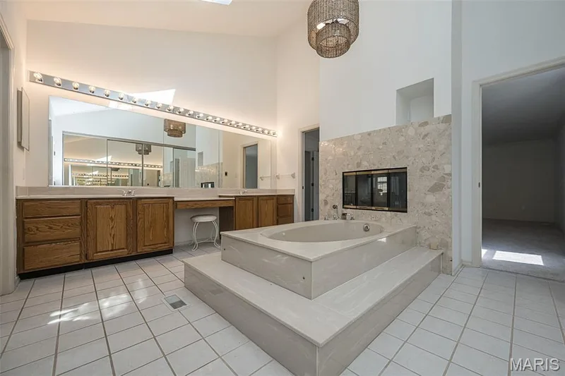Skylights flood the primary bathroom with natural light — 440 Meramec Way, St Charles, MO 63303