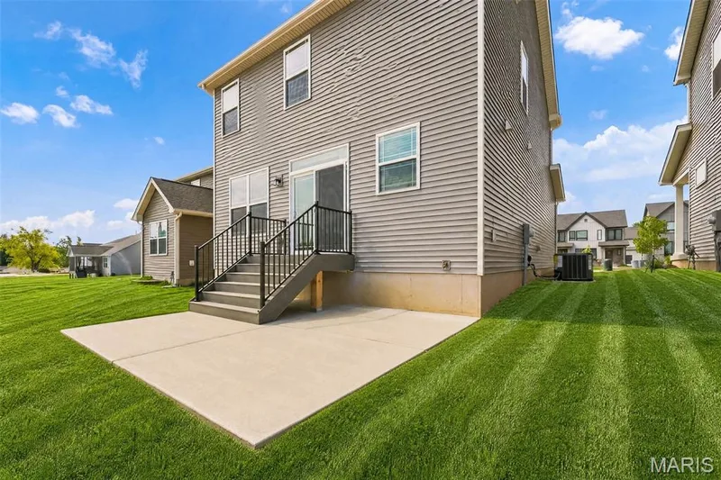 Back of home with Large Patio — 32 Wingtip Court, St Peters, MO 63376