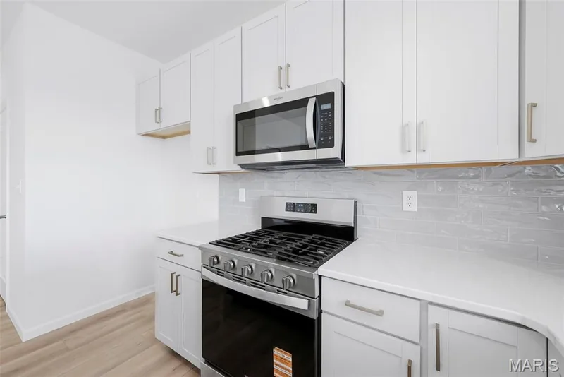 Kitchen with Gas Range and Stainless Steel Appliances — 32 Wingtip Court, St Peters, MO 63376