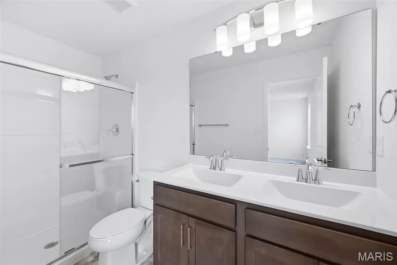 Primary Bathroom with Raised Height Double Bowl Vanity and a Step In Shower. — 32 Wingtip Court, St Peters, MO 63376