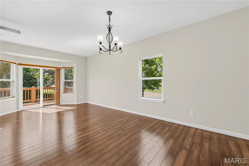 Dining Area and Living Room with 9 Foot Ceilings and Wood Laminate Flooring — 1700 Coupru Court, St Peters, MO 63376