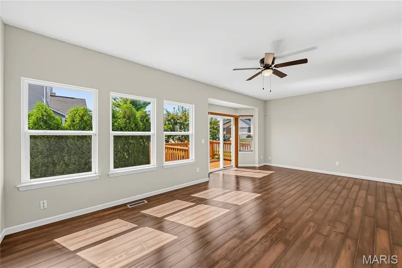 Living Room with Wall of Windows and Bay Window with Sliding Glass Door opening to  Deck — 1700 Coupru Court, St Peters, MO 63376