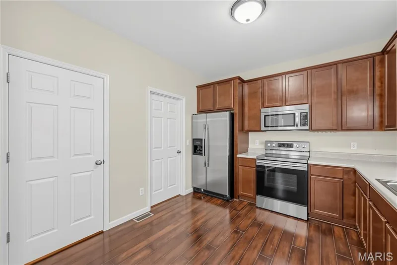 Stainless Steel Appliances and Pantry in Kitchen — 1700 Coupru Court, St Peters, MO 63376