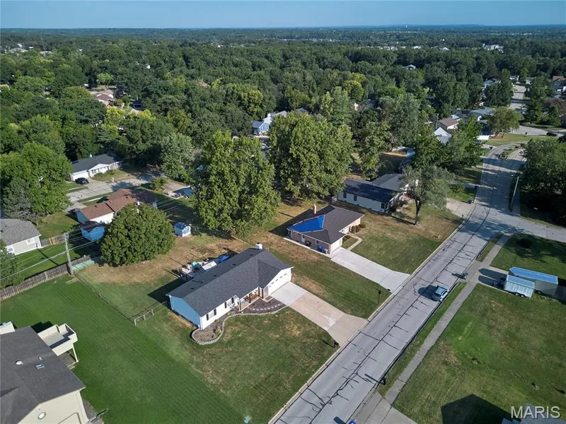 Ranch-style residence featuring a dark shingle roof, white siding, and an attached two-car garage — 415 Westridge Drive, O'Fallon, MO 63366