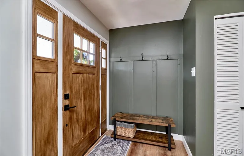Wood-finish flooring with a durable entryway door, sidelights, and transoms — 415 Westridge Drive, O'Fallon, MO 63366