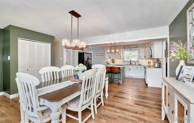 Wood-finish flooring throughout, with a multi-light chandelier and a built-in closet with louvered bi-fold doors — 415 Westridge Drive, O'Fallon, MO 63366