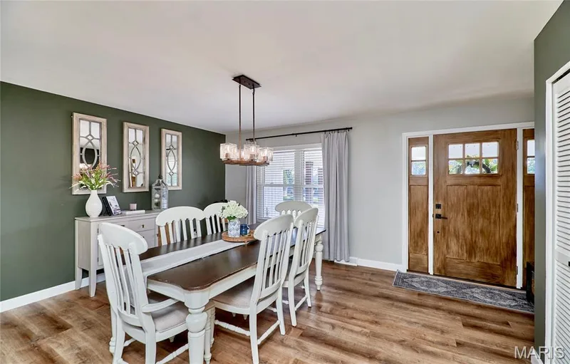 Wood-finish flooring throughout, complemented by a wood-paneled entry door with glass inserts — 415 Westridge Drive, O'Fallon, MO 63366