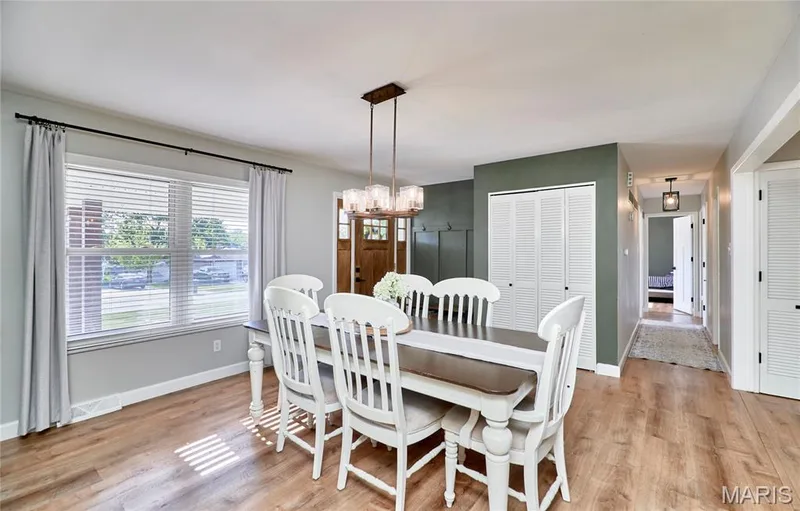 Wood-finish flooring throughout, a modern chandelier, and a large front window with blinds — 415 Westridge Drive, O'Fallon, MO 63366