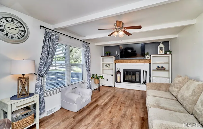 Wood-finish flooring with an integrated fireplace and built-in shelving — 415 Westridge Drive, O'Fallon, MO 63366