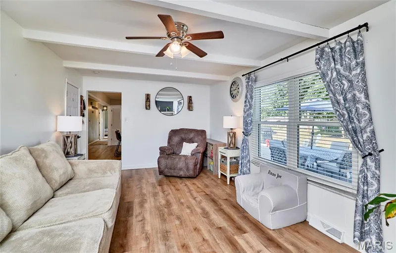 Wood-finish flooring throughout, with exposed ceiling beams and a ceiling fan — 415 Westridge Drive, O'Fallon, MO 63366