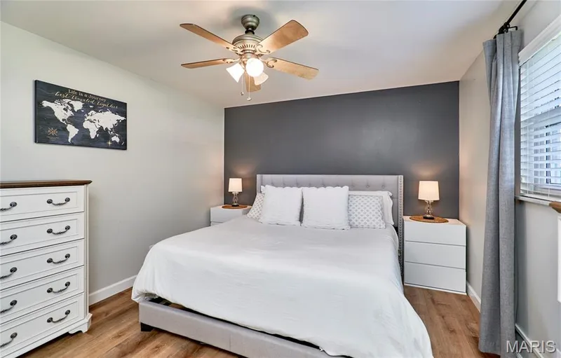 Wood-finish flooring with a multi-blade ceiling fan and window with blinds — 415 Westridge Drive, O'Fallon, MO 63366