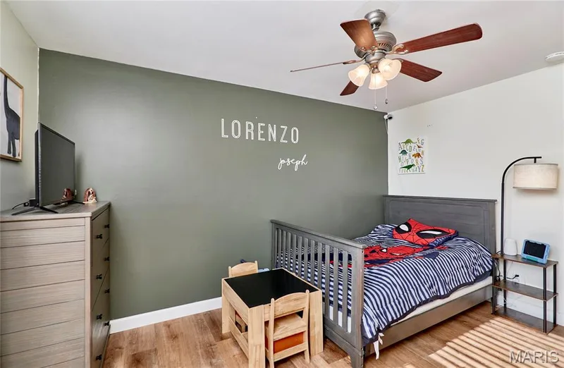 Wood-finish flooring, ceiling fan with integrated lighting, two-tone wall paint, and a built-in closet — 415 Westridge Drive, O'Fallon, MO 63366
