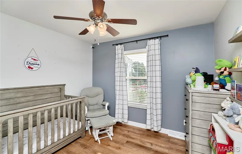 Recessed window with blinds, wood-finish flooring, and a ceiling fan with integrated lighting — 415 Westridge Drive, O'Fallon, MO 63366