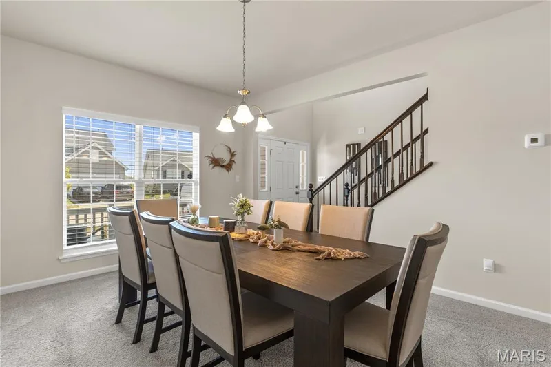 Spacious interior with carpet flooring and ample natural light through a large window — 211 Brookview Way Court, O'Fallon, MO 63366
