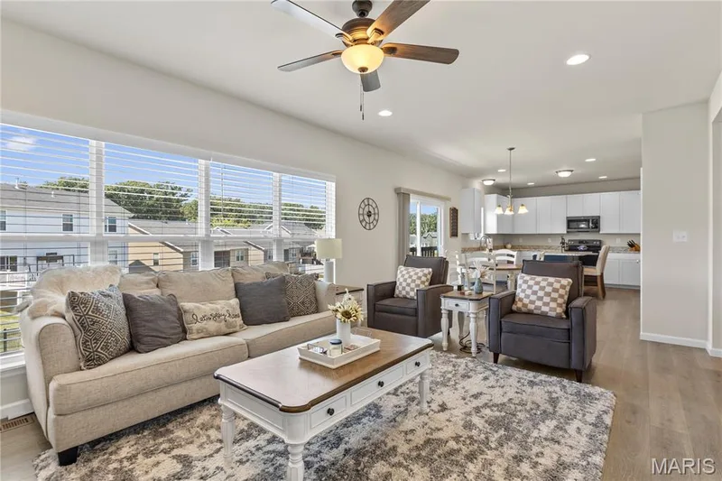 Open concept living area with wood laminate flooring — 211 Brookview Way Court, O'Fallon, MO 63366