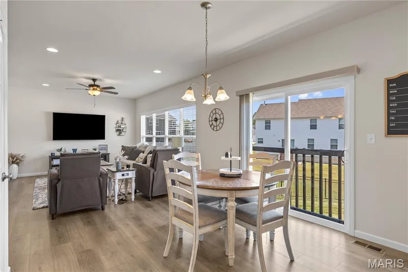 Open concept living space with wood laminate flooring, recessed lighting, and a ceiling fan — 211 Brookview Way Court, O'Fallon, MO 63366