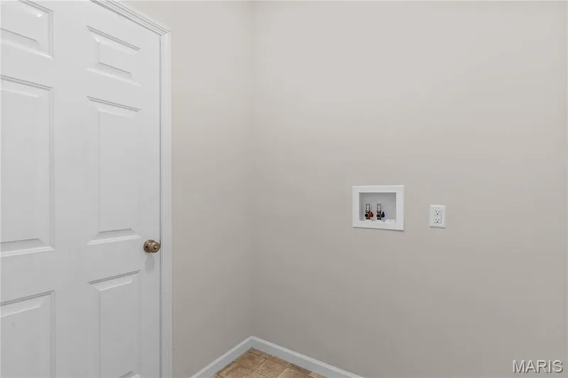 Neutral wall paint, tile flooring, and a white panel door — 211 Brookview Way Court, O'Fallon, MO 63366