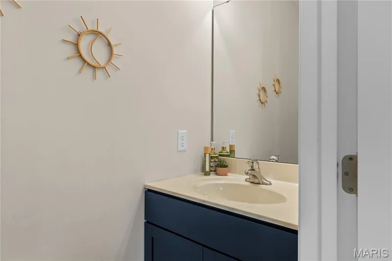 Vanity with integrated sink, chrome faucet, and base cabinet — 211 Brookview Way Court, O'Fallon, MO 63366