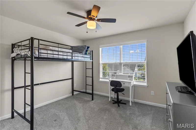 Carpeted flooring, window with horizontal blinds, and a ceiling fan with integrated lighting — 211 Brookview Way Court, O'Fallon, MO 63366