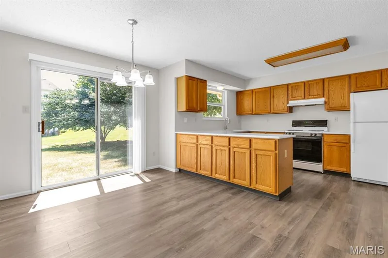 Sliding glass doors with new blinds walks out to the patio — 882 Sara Beth Court, St Peters, MO 63376