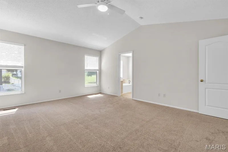 View 2 primary bedroom features lots of windows & ceiling fan — 882 Sara Beth Court, St Peters, MO 63376
