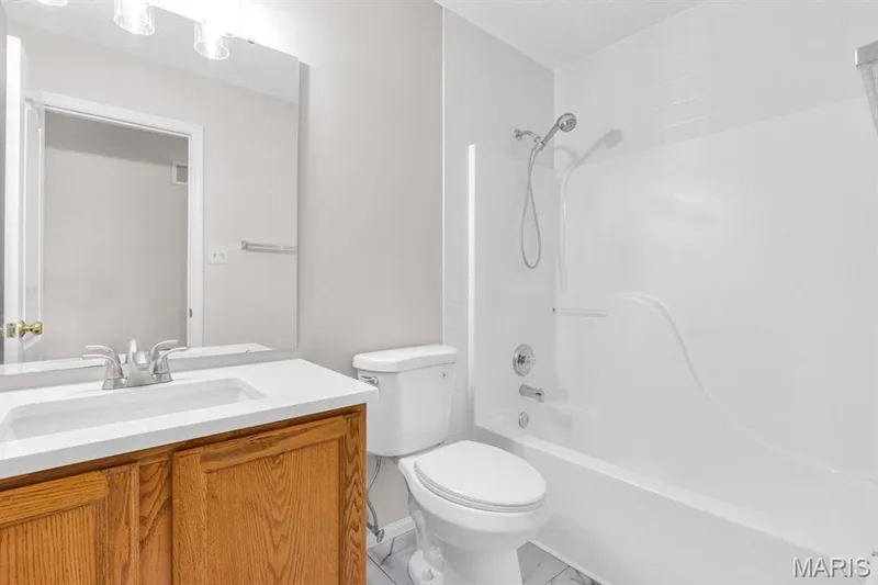 Hall bathroom with new quartz countertop & sink plus new luxury vinyl tile — 882 Sara Beth Court, St Peters, MO 63376