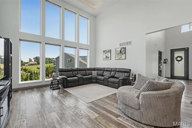 Vaulted ceiling with a wood-finish flooring — 18 MacArthur Court, St Charles, MO 63304