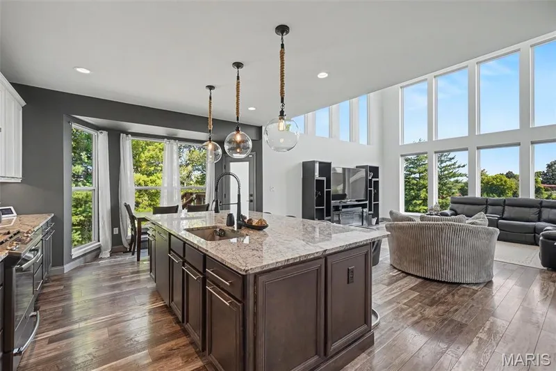 Gourmet kitchen island with an undermount sink, granite countertop, and pendant lighting — 18 MacArthur Court, St Charles, MO 63304
