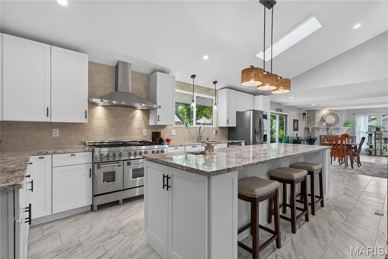 Beautiful kitchen with big center island with prep sink, granite counters — 202 Rue Grand Drive, Lake St. Louis, MO 63367