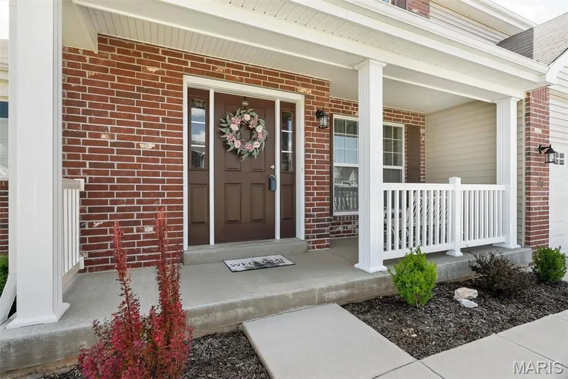 Covered front porch featuring brick and siding exterior — 337 White Orchid Court, Wentzville, MO 63385