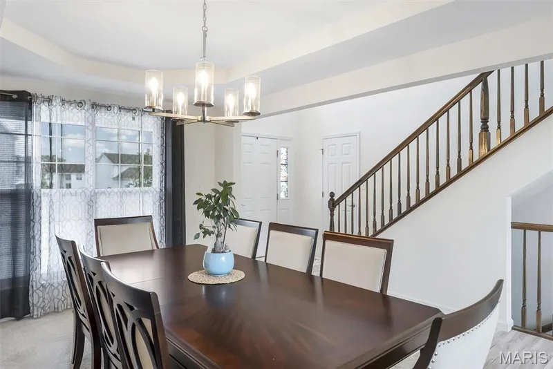 Recessed ceiling, multi-pane windows, wood-finish staircase with balusters, and a contemporary chandelier — 337 White Orchid Court, Wentzville, MO 63385