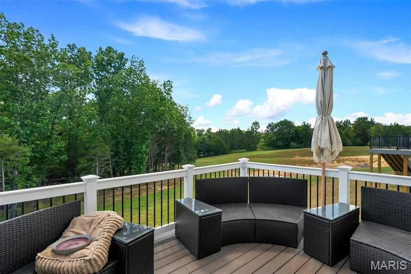 Outdoor deck with composite flooring, white railing, and black balusters — 337 White Orchid Court, Wentzville, MO 63385