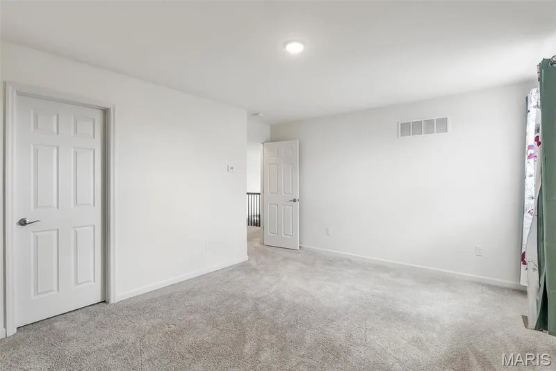 Neutral gray carpet flooring, recessed ceiling lighting, white six-panel interior doors, and white walls — 337 White Orchid Court, Wentzville, MO 63385