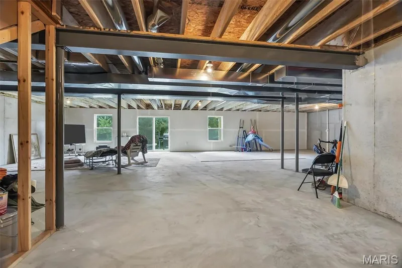 Unfinished basement with concrete flooring and exposed ceiling joists — 337 White Orchid Court, Wentzville, MO 63385