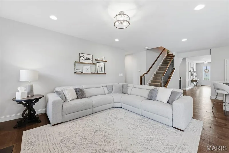 Hardwood-style flooring throughout, recessed lighting, and  upgraded carpeted staircase & wood railing and metal balusters — 140 Oakleigh Park Lane, St Charles, MO 63303