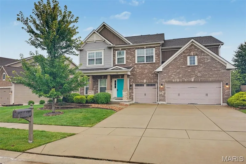 Property features a level yard, lawn irrigation system, and 3-car garage. — 152 Carlton Point Drive, Wentzville, MO 63385