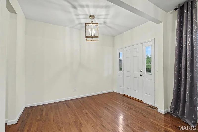 Entry foyer showcases the 10' ceilings and hardwood floors throughout. — 152 Carlton Point Drive, Wentzville, MO 63385