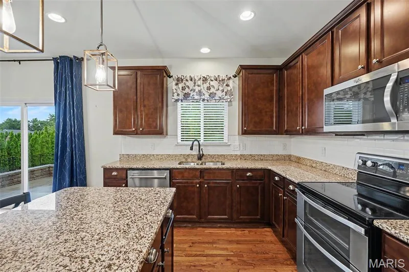 Tiled back-splash, upgraded cabinetry, and stainless appliances. — 152 Carlton Point Drive, Wentzville, MO 63385