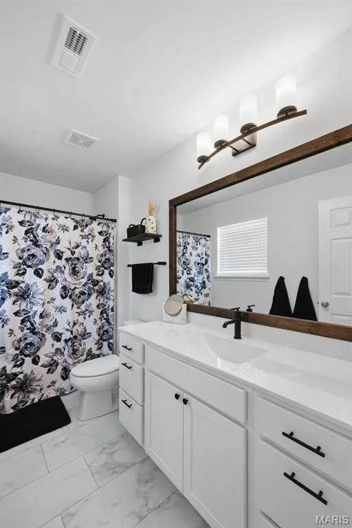 White shaker-style vanity with matte black hardware, white countertop, and integrated sink — 191 Crestfield Court, St Charles, MO 63301