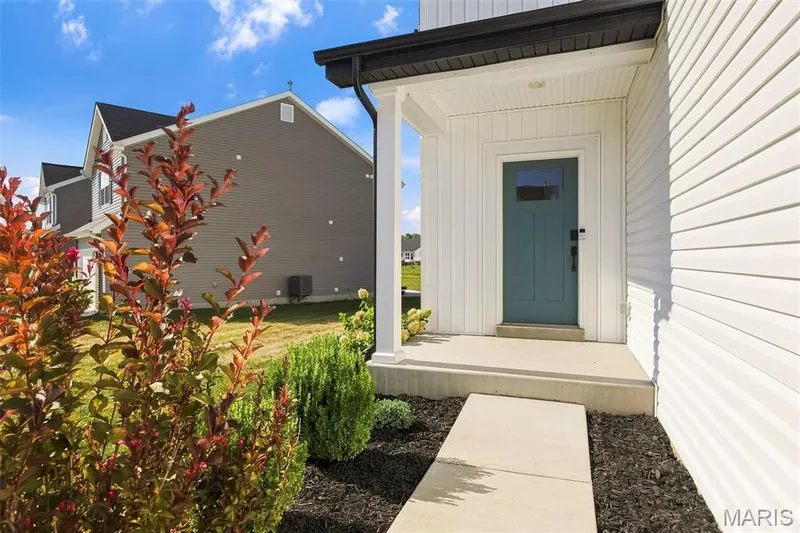 Covered front porch with white siding and dark green entry door — 191 Crestfield Court, St Charles, MO 63301