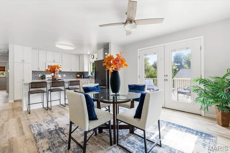 Crisp white cabinets and bold patterned tile bringing distinct character to an open, light-filled layout. — 1808 Cherry Tree Street, St Peters, MO 63376