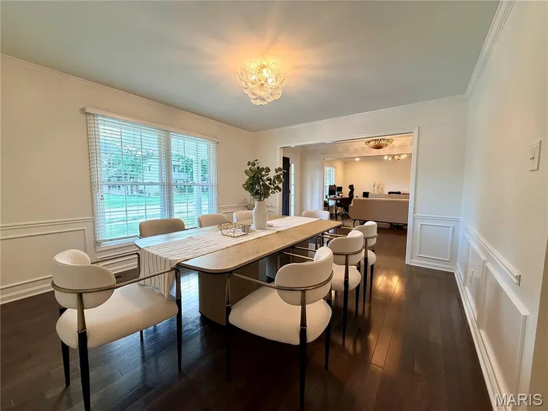 Hardwood flooring, decorative wall molding, window with blinds, and an overhead light fixture — 584 Sunbridge Drive, Chesterfield, MO 63017