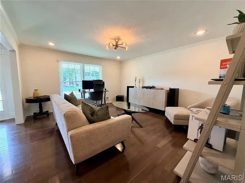 Recessed lighting, crown molding, wood-finish flooring, large window with blinds, and a built-in wall cabinet — 584 Sunbridge Drive, Chesterfield, MO 63017